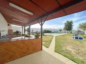 an open patio with a view of a yard at Casa Rural La Vega in Antequera