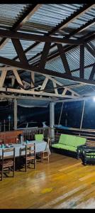 a room with several beds and chairs in a building at Greenland Eco Amazon Lodge in Paucartambo
