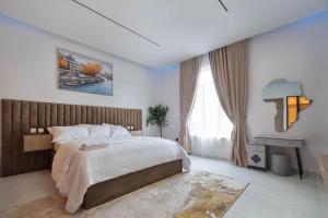 a bedroom with a large bed and a desk at Lisa homes 2 3bedroom in Lekki +9 photos