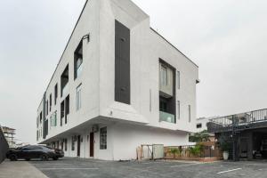 a building with a car parked in a parking lot at Lisa homes 2 3bedroom in Lekki