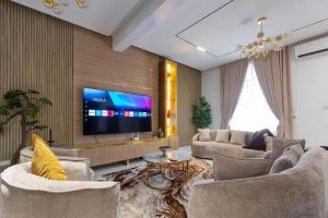 a living room with couches and a flat screen tv at Lisa homes 2 3bedroom in Lekki