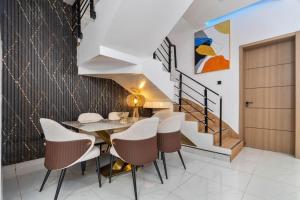 a dining room with a table and chairs and a staircase at Lisa homes 2 3bedroom in Lekki