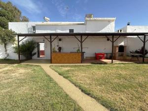 a white house with a porch and a yard at Casa Rural La Vega in Antequera +16 photos
