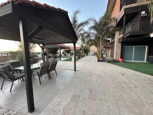 a patio with a table and chairs on a patio at carmel cabins suite nu 8 in Haifa