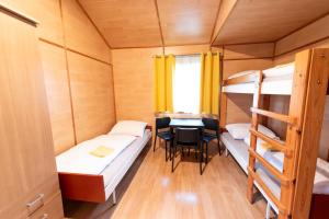 a small room with two bunk beds and a table at CAMP VARY - Vítkova Hora in Karlovy Vary