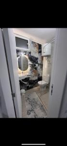 a bathroom with a sink and a toilet and a mirror at royal room in Ulcinj