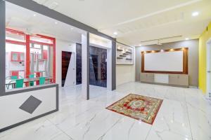 a large room with a projection screen and a rug at OYO Hotel O Amaravathi Road Annapurna Nagar in Guntūr