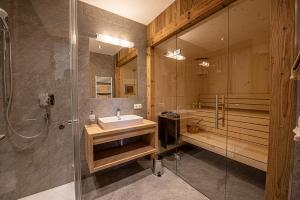a bathroom with a sink and a shower at AppartMO 243 Top 1 in Krimml