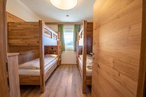 a room with two bunk beds and a window at AppartMO 243 Top 1 in Krimml