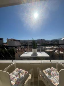 a table and chairs on a balcony with a view at My Chios Apartments in Chios