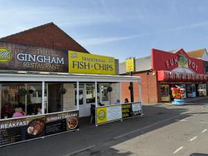 a group of fast food restaurants in a street at Bell Bank C8 - pet friendly, bed linen, close to bars and shops - Meadow Lakes Caravan & Lodge Hire in Chapel Saint Leonards