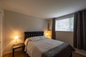 a bedroom with a bed and a window at EdenCat Condo - Mountain View in Beaupré