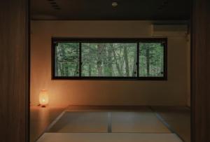 a room with a window and a lamp on the floor at Fandina Fujiwara in Azumaiokozan +50 photos