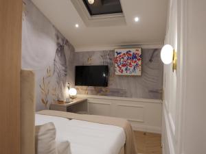 a bedroom with a bed and a tv on a wall at Agava Design Residence in Split