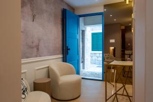 a living room with a blue door and a chair at Agava Design Residence in Split