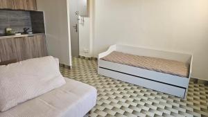 a bedroom with a bed and a couch in it at La casa de valras in Valras-Plage