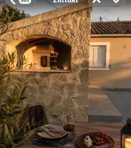 an outdoor pizza oven in a stone wall at Villa Armando Corfu Jacuzzi in Perama +11 photos