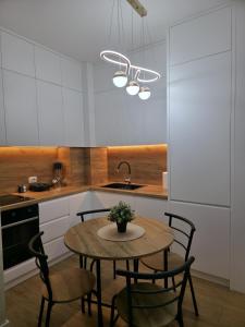 a kitchen with a table with chairs and a sink at E&O Apartment in Pogradec
