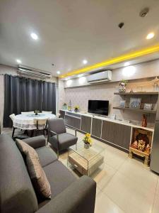 a living room with a couch and a table at Shell Residence Pasay City in Manila