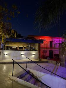 a lit up building with red and pink lights at El Viejo Molino in Chilecito