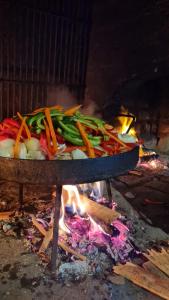 a tray of vegetables cooking over a fire at El Viejo Molino in Chilecito