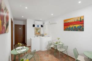 a dining room with tables and chairs and a kitchen at Villevieille in Piano di Sorrento