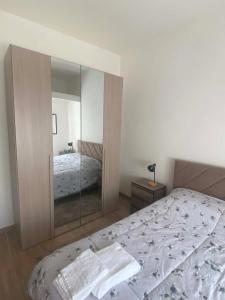 a bedroom with a bed with a mirror on it at Lo chalet sul lago in Ispra