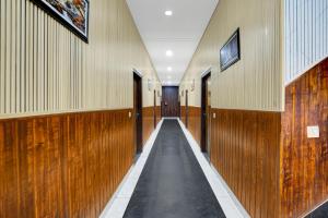 an empty hallway with wooden walls and doors at Super Hotel O by OYO Silver Arc Mall Ludhiana Formerly White Solitaire 1 in Ludhiana