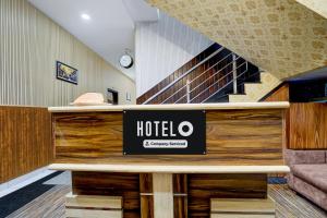 a hotel lobby with a hotel sign on a desk at Super Hotel O by OYO Silver Arc Mall Ludhiana Formerly White Solitaire 1 in Ludhiana