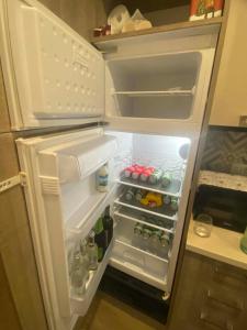 an open refrigerator filled with drinks and bottles at Lo chalet sul lago in Ispra