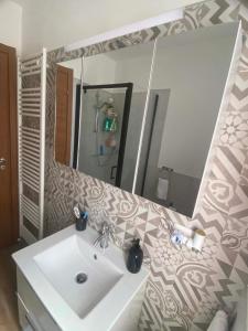 a bathroom with a sink and a mirror at Lo chalet sul lago in Ispra +28 photos