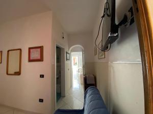 a view of a living room with a blue couch at ZIO DOMENICO Al Vicolo in Castellabate