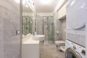 a bathroom with a sink and a shower and a toilet at Bright Sea View Home, Steps from the Beach in Lavagna +26 photos