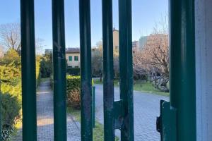 an open door with a view of a driveway at Design Villa with parking Navigli Milan sleeps5 in Milan