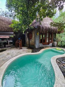a small swimming pool in front of a hut at Les Garden villa in Tejakula