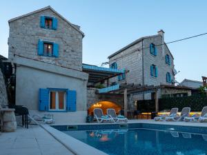 a house with a swimming pool in front of a building at Agava Design Residence in Split