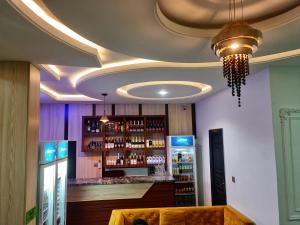 a room with a bar with a wine rack at Sennet Luxury Hotel in Uyo