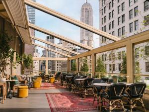 a balcony with tables and chairs and a view of a city at Madison Square Studio at Return Policy Broadway in New York