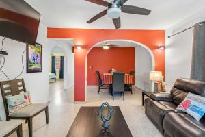 a living room with a couch and a table at Villa Jardin - Infinity Pool and Backyard Oasis in Luquillo