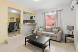 a living room with a couch and a table at Villa Jardin - Infinity Pool and Backyard Oasis in Luquillo +59 photos