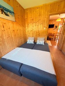 a room with two beds in a wooden wall at ZEFIR Dąbki in Dąbki +71 photos