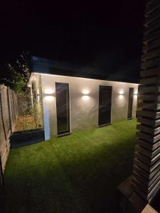 a house with lights on the side of it at night at The Out House in Hemel Hempstead