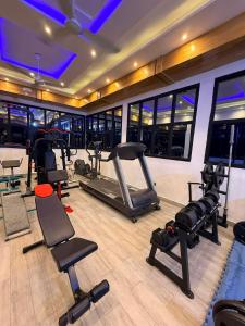 a gym with treadmills and exercise equipment in a building at RAWADE Guesthouse in Cotonou