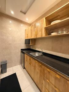 a kitchen with a sink and a counter top at RAWADE Guesthouse in Cotonou