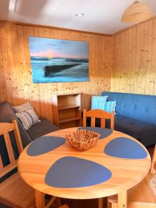 a living room with a table and a couch at ZEFIR Dąbki in Dąbki
