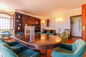 a living room with a wooden table and chairs at Bela Vista in Azambuja +41 photos