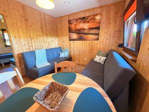 a living room with a couch and a table at ZEFIR Dąbki in Dąbki