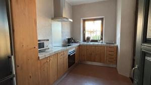 a kitchen with a sink and a microwave at Ca La Botera in Verges +21 photos