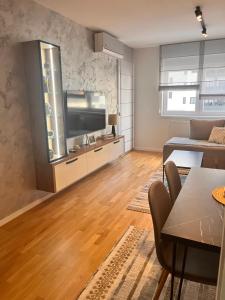 a living room with a large flat screen tv at Apartman A&V in Vranješ