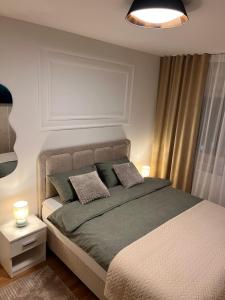 a bedroom with a large bed with two pillows at Apartman A&V in Vranješ